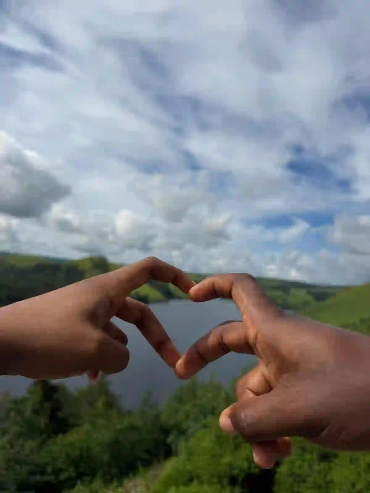 Heart hands over the lake
